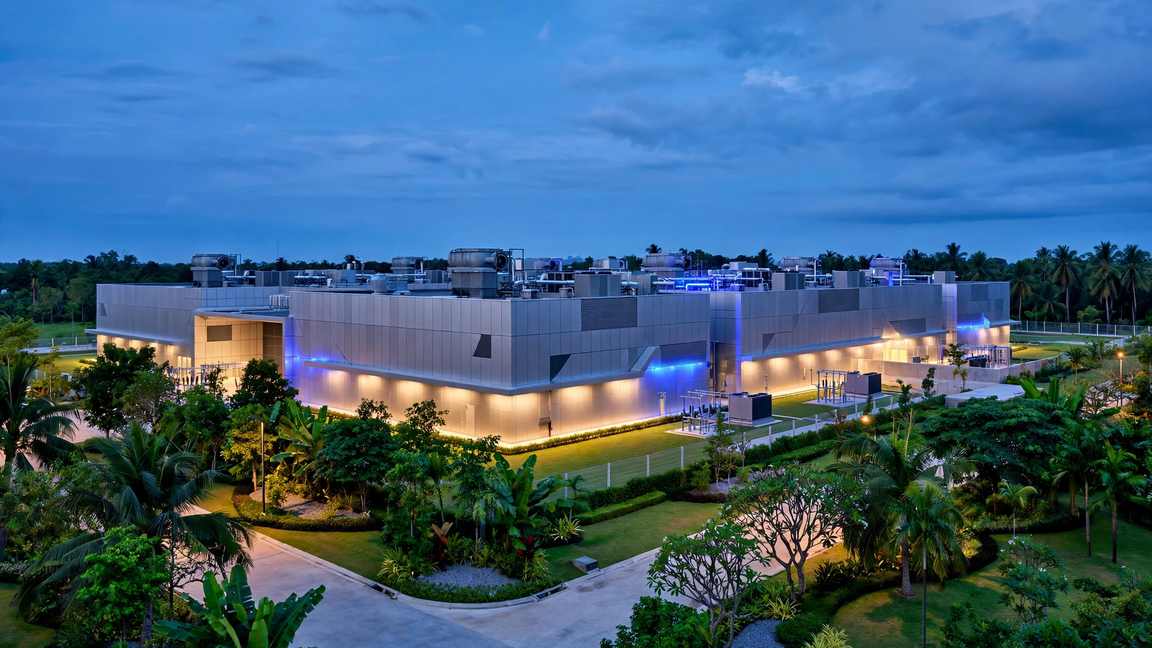 A modern hyperscale data centre in Southeast Asia at dusk